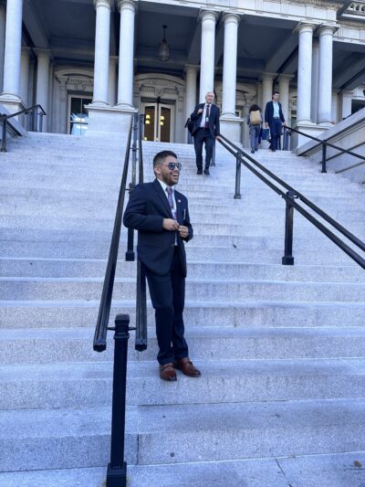 ACLU Arkansas Policy Director Kevin Azanza is seen leaning against railing on the front steps of the White House in Washington D.C.