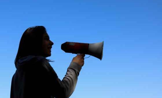 Person in shadows holding megaphone