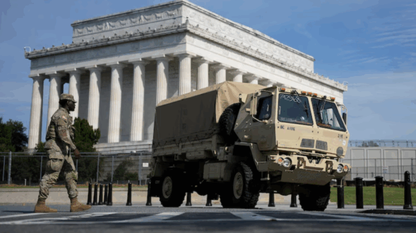 A member of the National Guard stands next to a Guard truck outside the Lincoln Memorial in Washington, D.C.