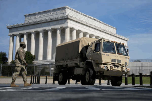A member of the National Guard stands next to a Guard truck outside the Lincoln Memorial in Washington, D.C.