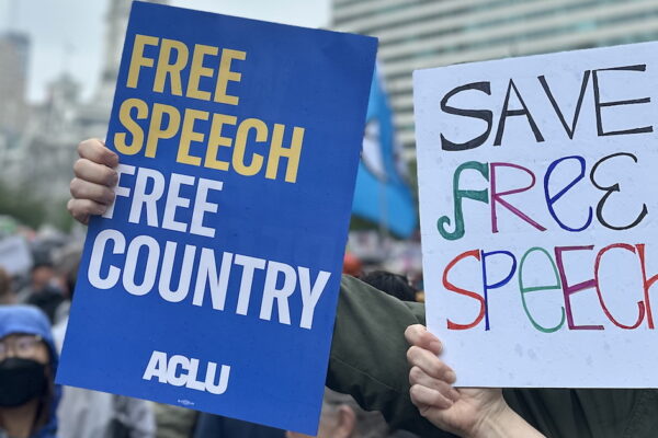 ACLU poster with FREE SPEECH, FREE COUNTRY written in yellow and white letters on blue background.