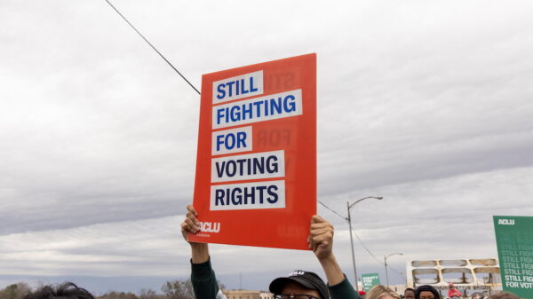 ACLU sign, blue text on white and red background reading, "Still Fighting for Voting Rights."