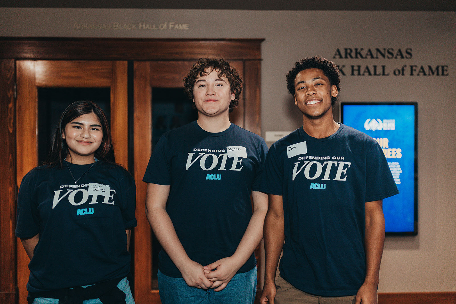ACLU of Arkansas volunteers Sofia, Blaze and Javi pose for a pic.