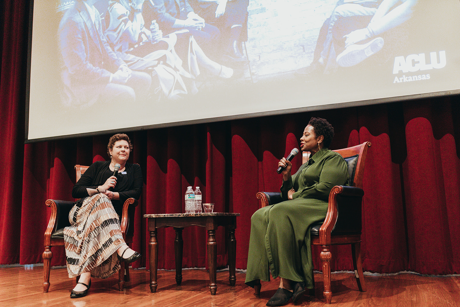 Holly Dickson, executive director for the ACLU of Arkansas and ACLU President Deborah Archer talk on stage.