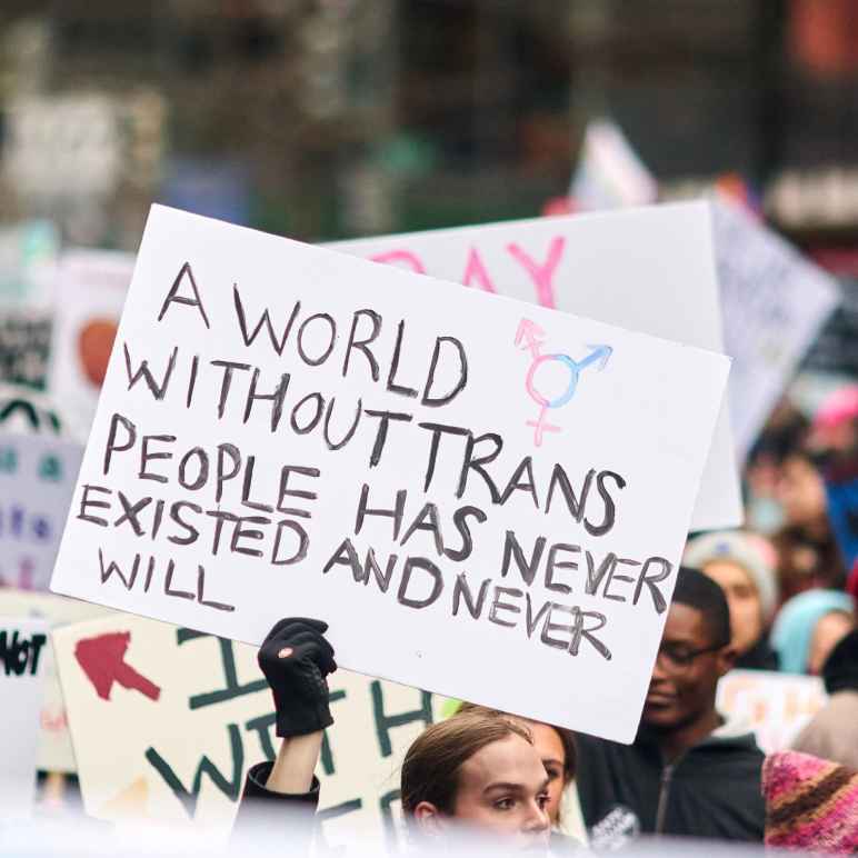 Protest sign that reads, "A world without trans people has never existed and never will."