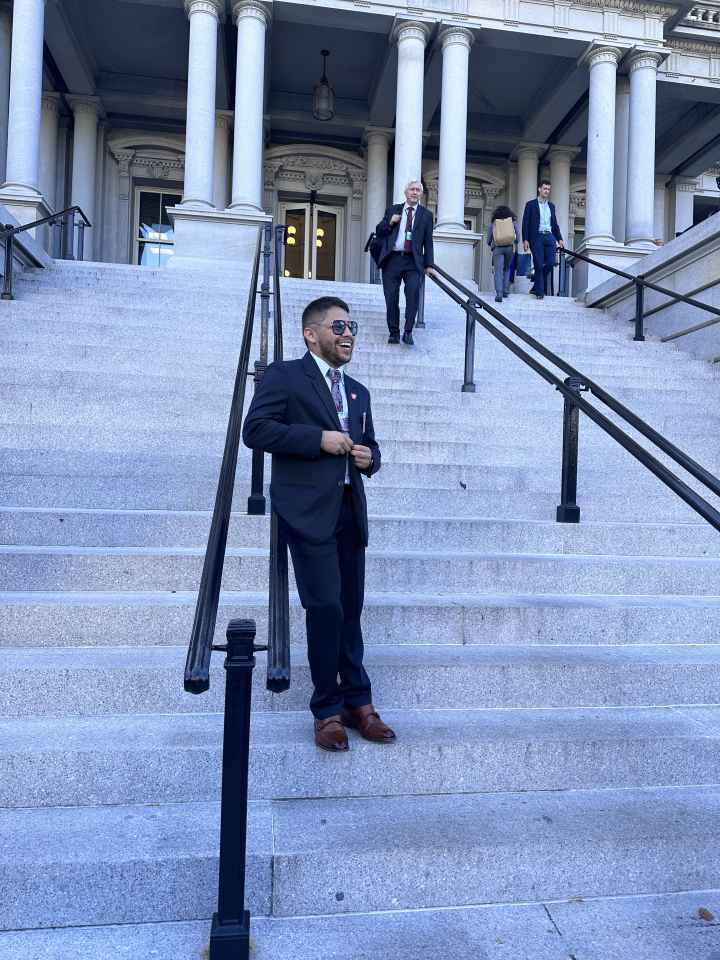 ACLU Arkansas Policy Director Kevin Azanza is seen leaning against railing on the front steps of the White House in Washington D.C.