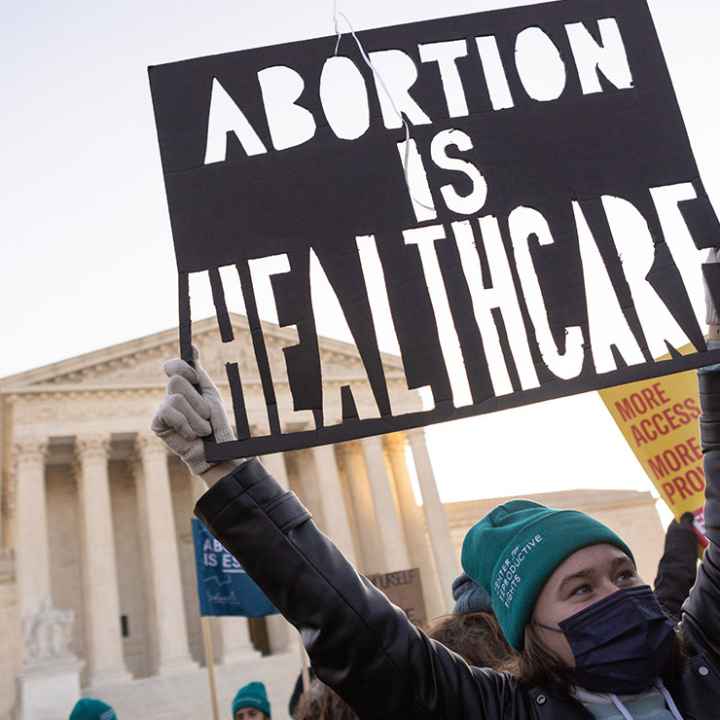 A person at a rally holding a sign that says “Abortion is Healthcare.”