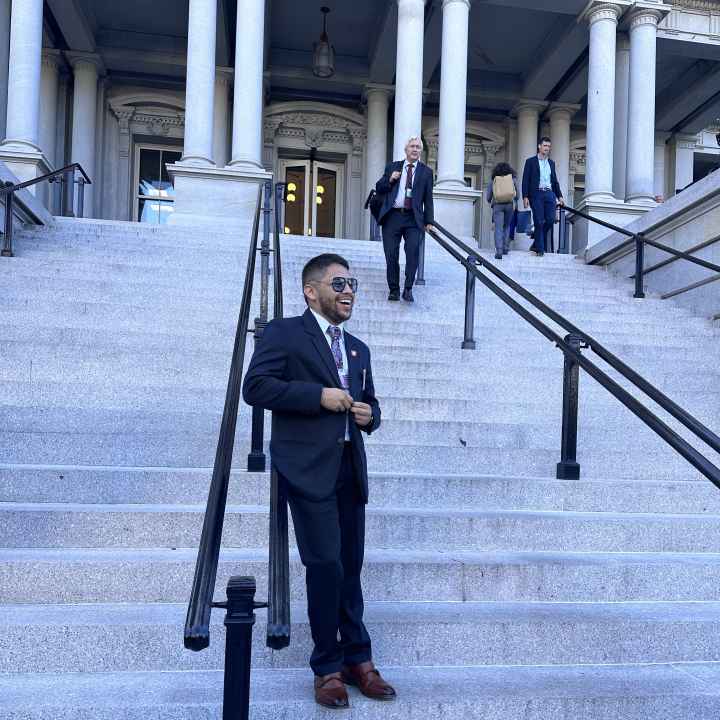 ACLU Arkansas Policy Director Kevin Azanza is seen leaning against railing on the front steps of the White House in Washington D.C.